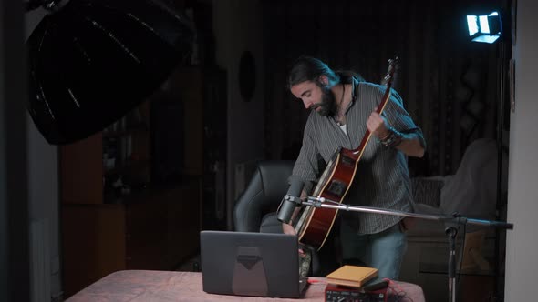 Young Bearded Musician Teaching His Student Each Part That a Guitar Has