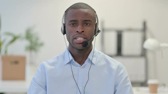 Portrait African Man Talking Through Headset Call Center