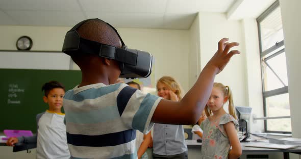 Schoolboy using virtual reality headset in classroom at school 4k