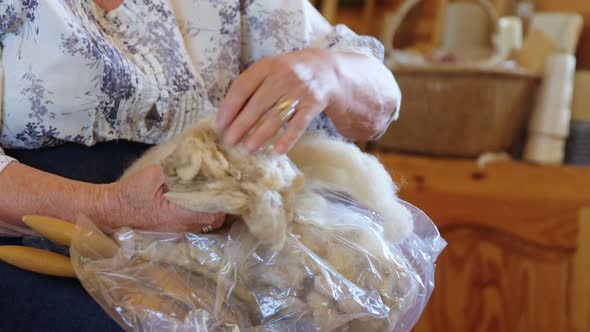 Senior woman sorting the wool 4K 4k