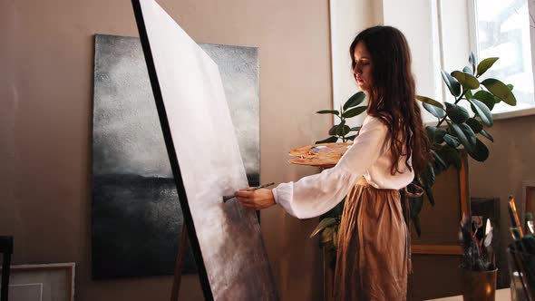 Art Studio  Young Woman Painting a Replica of Another Painting