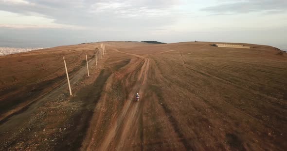 Aerial follow shot on motorcycle riding in countryside