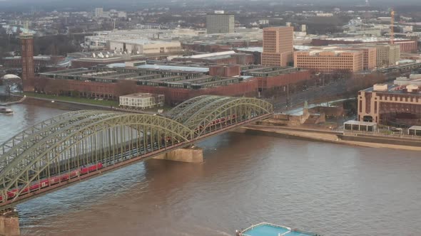 AERIAL: Over Cologne Old Town and View on Rhine and Hohenzollern Bridge with Train Crossing and Boat