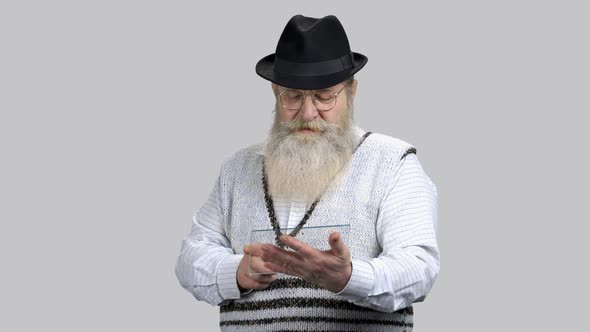 Old Bearded Man Scrolling and Swiping Glass Transparent Copyspace Tablet