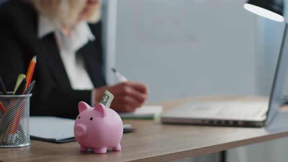 Piggy Bank Senior Business Woman Accountant Typing on Laptop Computer Calculating Money Income