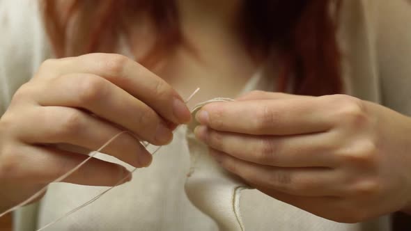 Women Sews a Cute Cloth Doll