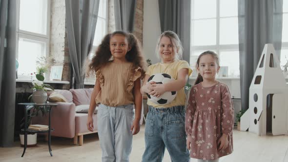 Portrait of Happy Little Girls with Soccer Ball