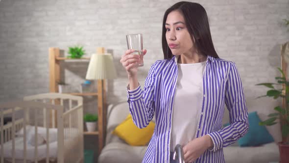 Positive Young Asian Woman Drinks Clean Fresh Water