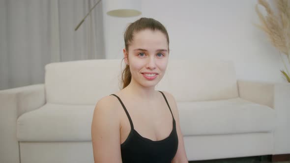 Young Beautiful Woman After Training at Home Looking at Camera Indoor