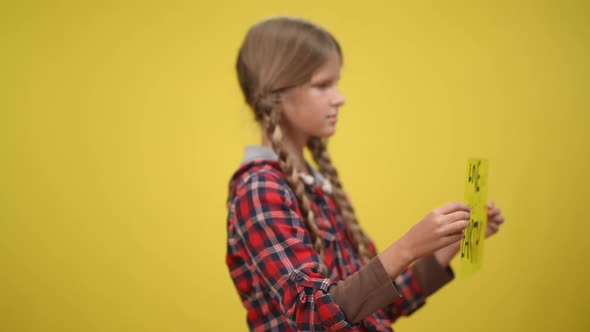 Love your Mother Earth Message on Placard with Blurred Teenage Caucasian Girl at Yellow Background