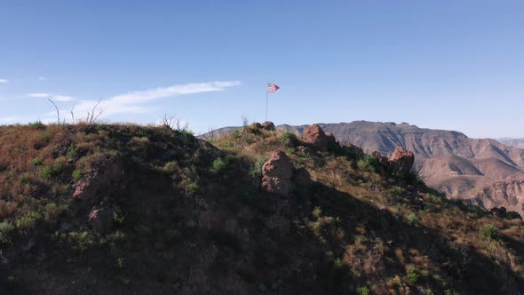 Camera Is Rising Up Above the USA Patriotic Flag Set Up in the Mountains. 