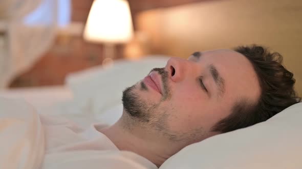 Portrait of Young Man Trying to Sleep in Bed