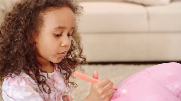 Little Girl Decorating Balloon