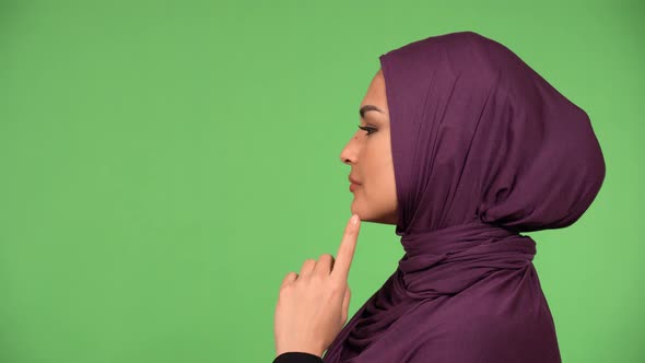 A Young Beautiful Muslim Woman Looks to the Side and Thinks About Something  Closeup  Green Screen