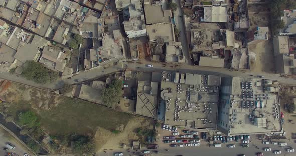 Bombay, India, Aerial zoom out of an old area, showing cars moving on a road, Another big road with