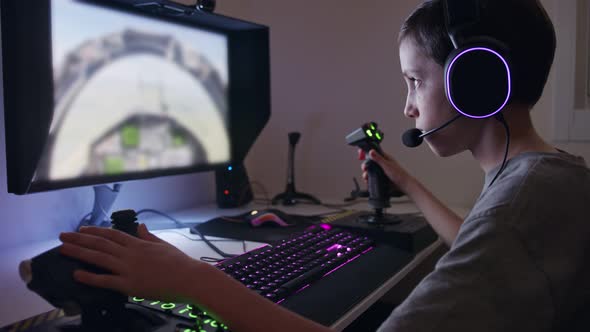 Young boy playing a flight simulator wearing a headset