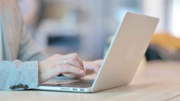 Close up of Man Typing on Laptop Keypad, Side View