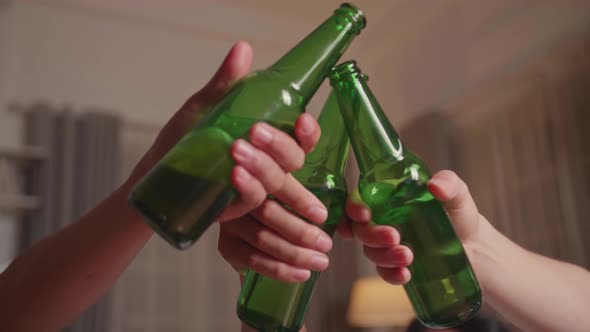 Close Up Clinking Bottles Of Beer