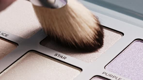 Powder Big Brush Gains Highlighter on Pile To Be Used in Make-up. Artist Working with Face Palette