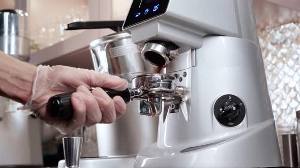 Close Up of Barista Hands Preparing Coffee in Coffee Machine