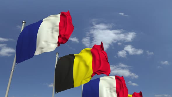 Flags of Belgium and France Against Blue Sky alt