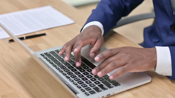 African Businessman Hands Typing on Laptop 