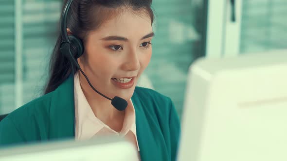 Businesswoman Wearing Headset Working Actively in Office