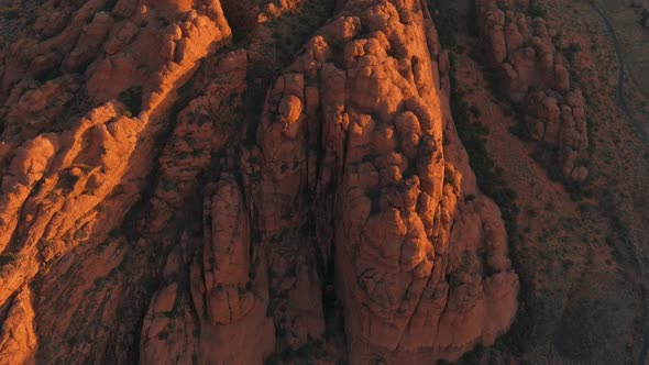 Aerial shot lowering over Utah's Snow Canyon State Park during sunrise.