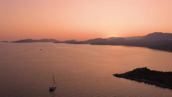 Aerial Drone View of Red Sunset Sky Over Sea and Mountains