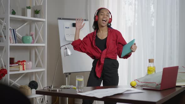 Excited Joyful Satisfied Woman in Headphones Dancing in Slow Motion in Home Office