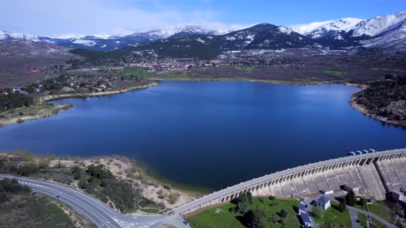 Incredible high angle aerial view over the Reservoir and Dam of Navacerrada in Spain.