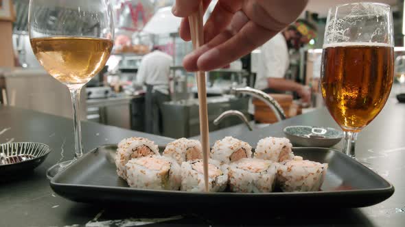 Eating sushi rolls in Japanese restaurant