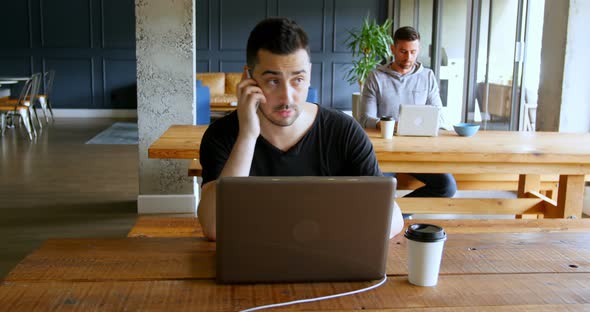 Executives working on table in office cafeteria 4k