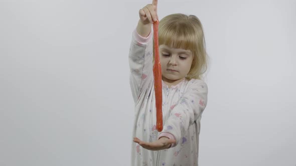 Kid Playing with Hand Made Toy Slime. Child Having Fun Making Pink Slime