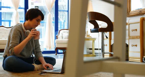 Woman using mobile phone in living room