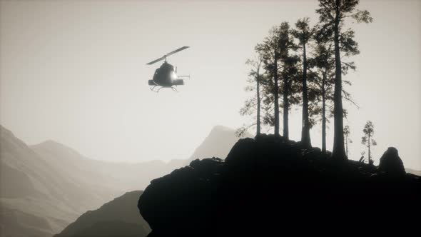Extreme Slow Motion Flying Helicopter Near Mountain Forest alt