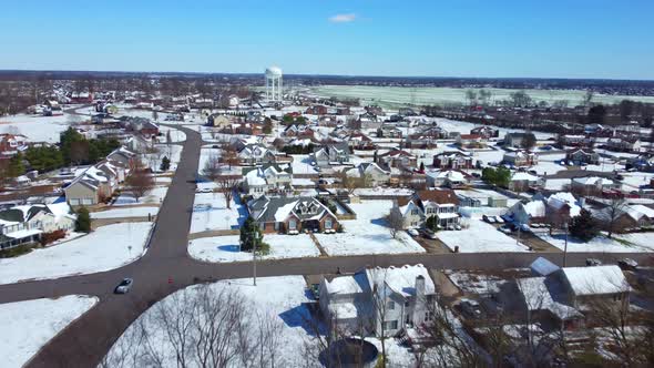 Flying over a suburban neighborhood after a day of snow