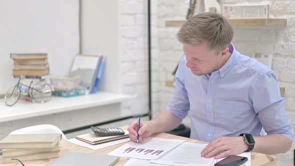 Focused Businessman Working on Finance Documents