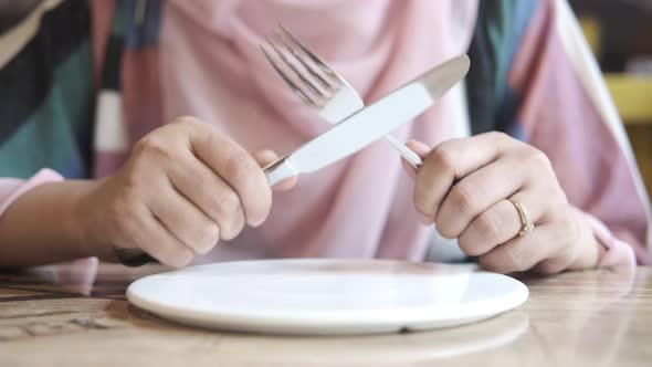 Women Hand Holding Cutlery with Empty Plate Waiting for Food