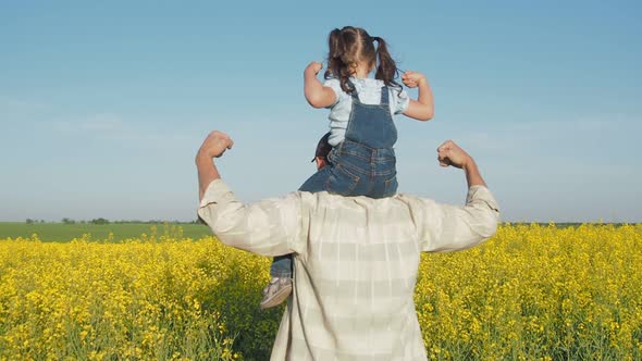 A Man Is Playing with a Child on the Field