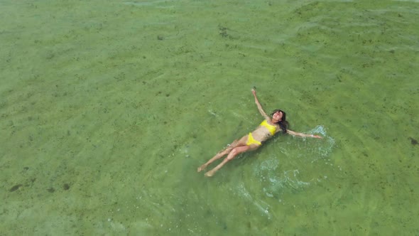 Aerial View Woman in Bikini Swimming in Calm Sea