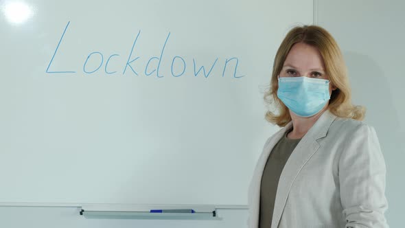 End of Quarantine  Woman Erases the Inscription Lockdown From the Classroom Board