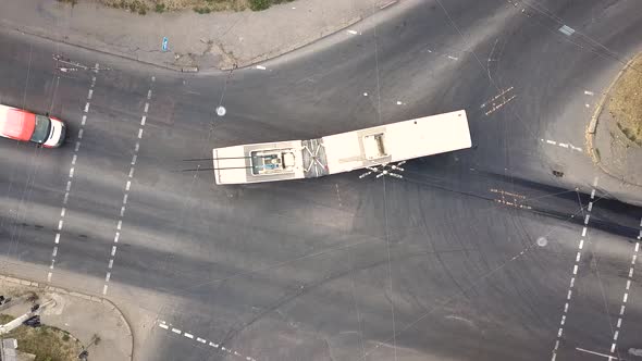 Top down aerial view of city traffic with cars moving on a street at roads intersection.