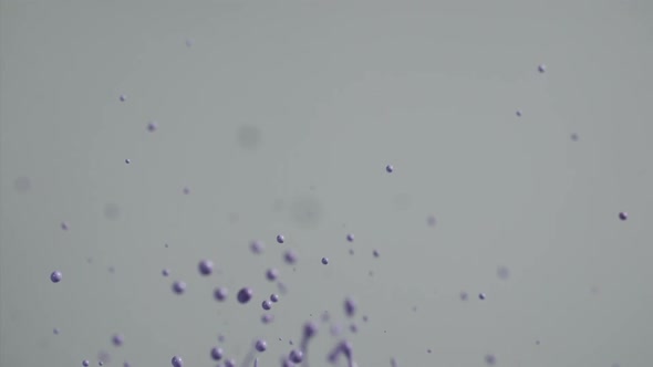 Purple Paint Flying Into Air Creating Abstract Patterns