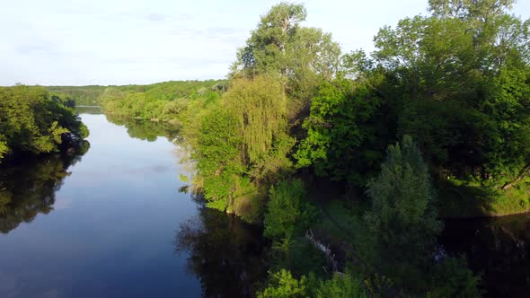 Aerial Drone View Flight Over Mirror Smooth Surface of River and Trees