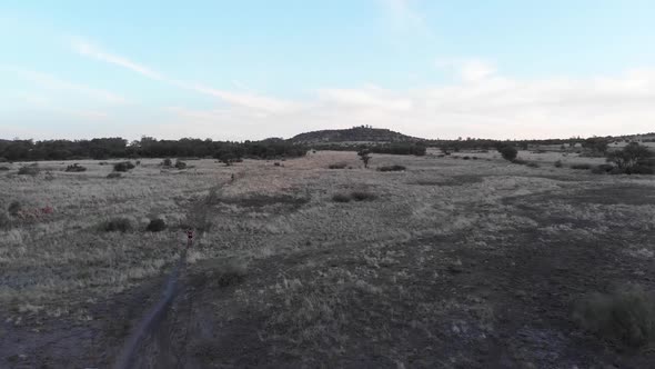 Drone Follow Two Mountain Bikers on a Cloudy Overcast Day