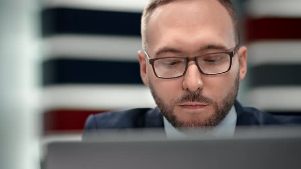 Closeup Face of Male in Glasses Work Online Communication Laptop Pc