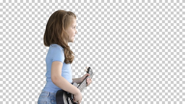 Cute little girl walking and singing while playing on ukulele