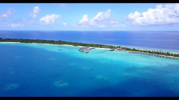 Aerial drone shot seascape of marine coastline beach journey by blue ocean with white sandy backgrou