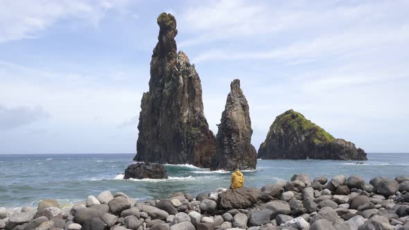 Woman looking at Ribeira da Janela islet in Madeira